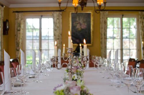 a long table with candles and glasses and flowers at Landgasthof zur Sonne in Wehr