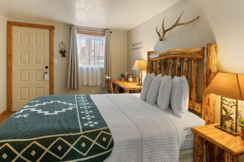 a bedroom with a large bed and a window at The Evergreen in West Yellowstone