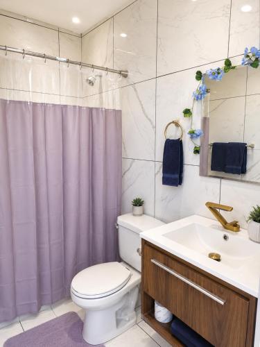 a bathroom with a toilet and a sink at Baddeck Domes in Baddeck