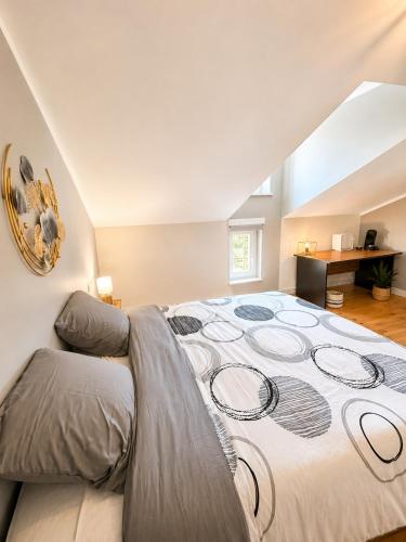 a large bedroom with a large bed in a attic at chambres d'hotes des capellas in Bessens