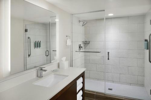 a white bathroom with a sink and a shower at Residence Inn by Marriott Palo Alto Menlo Park in Menlo Park