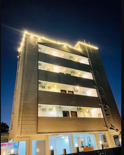 a tall building with lights on top of it at ishwari heights lodging in Pandharpur