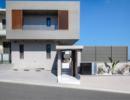a facade of a house with a building at Villa Nectar in Kounoupidhianá