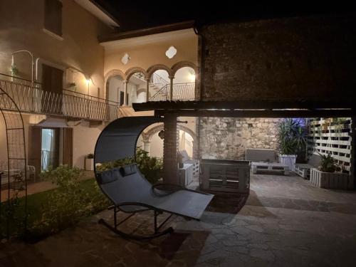 a house with a chair in a courtyard at night at Il Casale in Soiano del Lago
