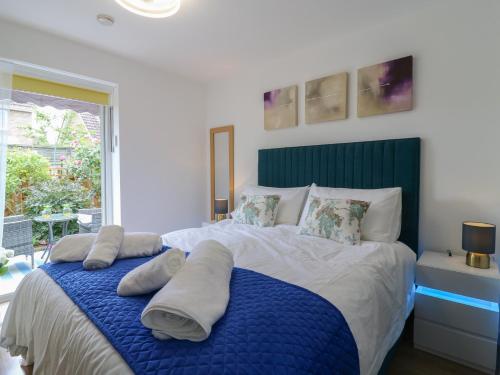 a bedroom with a large bed with towels on it at Oakwood Annexe in Colchester