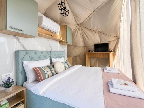 a bedroom with a bed in a tent at Sutjeska Glamping Domes in Tjentište