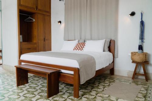 a bedroom with a large bed with a wooden frame at Authentic Colonial & Central in Campeche