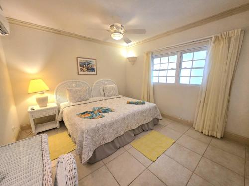 a bedroom with a bed and a window at Mistle Cove 102 in Christ Church