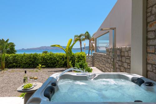 a hot tub in the backyard of a house at Sirin Luxury Suites Groundfloor in Haraki