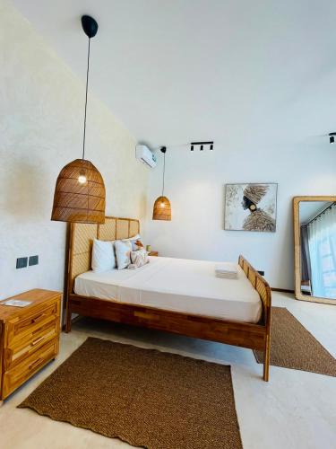 a bedroom with a bed and a dresser and a bed sidx sidx sidx sidx at Solymar Villa 3 in Jambiani