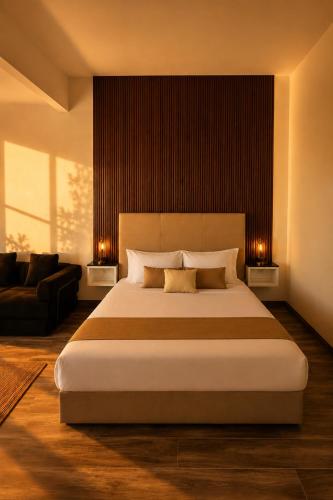 a bedroom with a large bed and a couch at Sed de Valle-Valle de Guadalupe in Ensenada