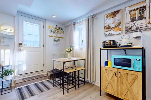 a kitchen with a small table and a tv at New & Modern Basement Suite - St Clair Hotel in Toronto