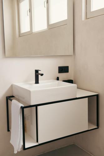 a bathroom with a white sink and a mirror at B&B Inn Between in Ghent