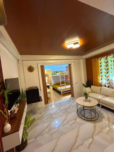 a living room with a couch and a table at Tiny house studio near SM City Daet in Daet