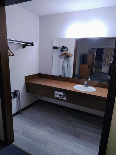 a bathroom with a sink and a mirror at Heritage Inn in Fairview