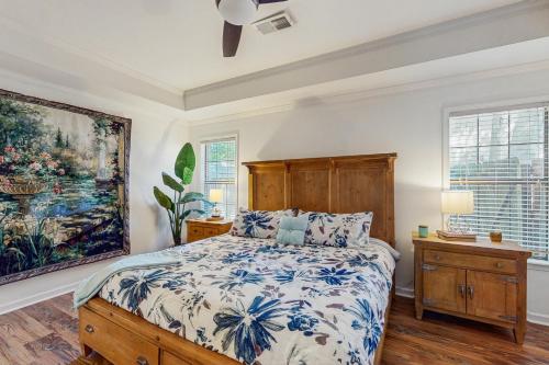 a bedroom with a bed and a painting on the wall at <1 Block to Trails! Conway Biker & Hikers Haven in Conway