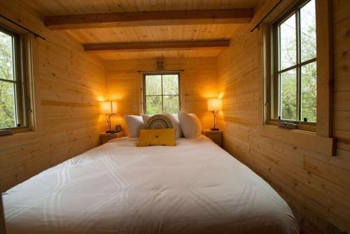 a bedroom with a large bed in a log cabin at Casa Rosa Unit C on Lake Conroe in Willis