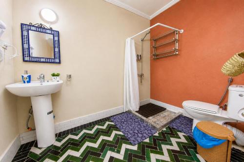a bathroom with a sink and a toilet at Riad Chada Fez in Fez