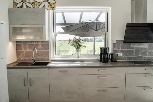 a kitchen with a sink and a window at Haus Weitwinkel in Sehestedt