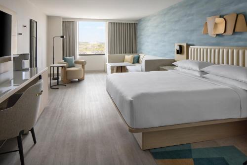 a bedroom with a large bed and a living room at Toronto Airport Marriott Hotel in Toronto