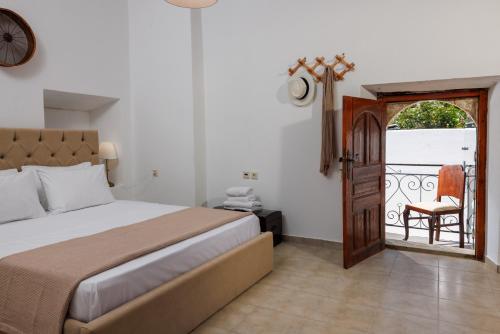a bedroom with a bed and a door to a balcony at Linas Concept in Fourfourás