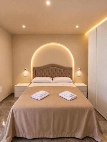 a bedroom with a large bed with two towels on it at Villa Elysia Tropea in Tropea
