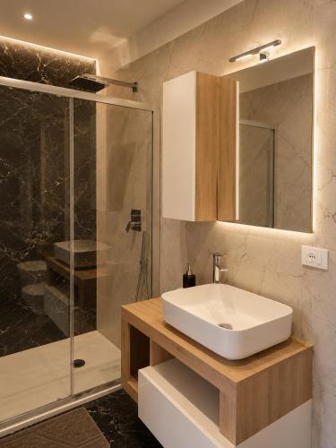 a bathroom with a sink and a shower at Villa Elysia Tropea in Tropea