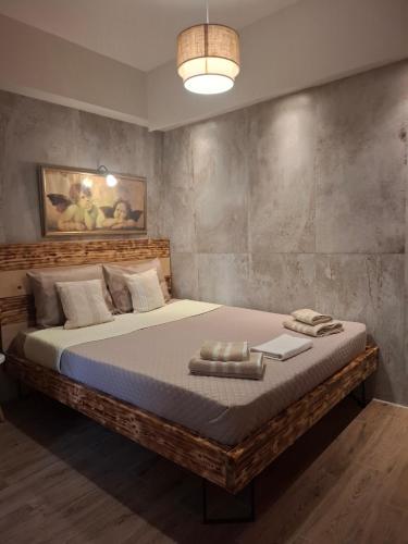 a bedroom with a large bed in a room at IL TRAMONTO APARTMENT 1 in Kanali