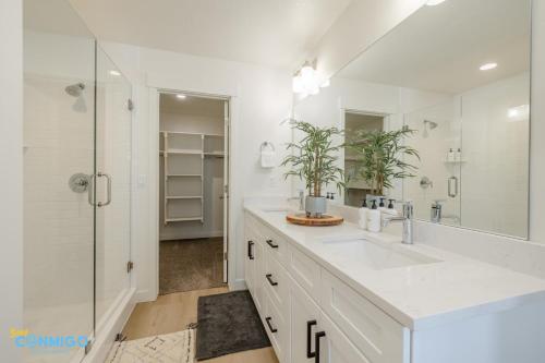 a white bathroom with a sink and a shower at Pooley Pad in American Fork