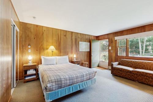 a bedroom with a bed and a couch at King Birch Lake Home, Unit 7 in Alton