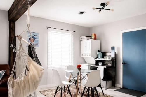 a living room with a hammock hanging from the ceiling at The PanAm fire pit bbq kid & dog friendly in Pensacola