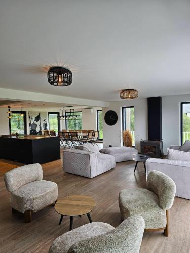 a living room with couches and chairs and a fireplace at Les Terrasses de Laloux in Rochefort
