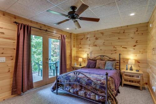 a bedroom with a bed and a ceiling fan at Treetops Hot Tub Fire Pit Pool Table in Copperhill