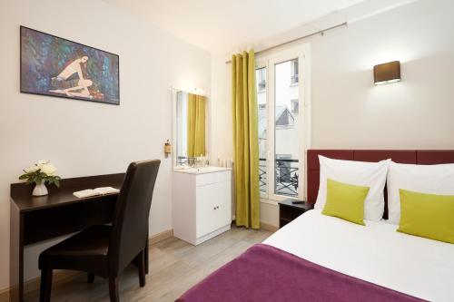 a bedroom with a desk and a bed and a desk at Hôtel Viator in Paris