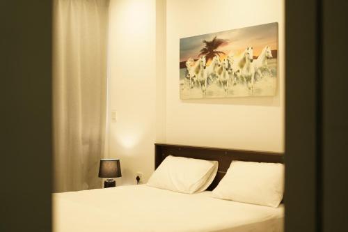 a bedroom with a bed with a picture of cows at Premium 2 Bedroom Apartment Near Airport in Muscat
