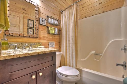 a bathroom with a toilet and a tub and a sink at Blueberry Hill Fire Pit MTN Views Grill in McCaysville