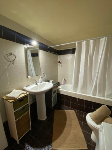 a bathroom with a sink and a toilet and a tub at Roxys sea view Santorini Monolithos in Santorini