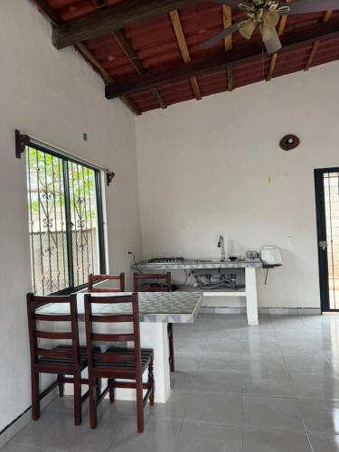 a room with a table and chairs and a kitchen at Casa ciruelo in Las Varas