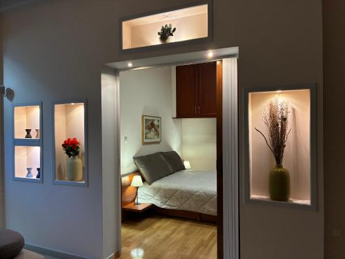 a bedroom with a mirror and a bed in it at Dream Home Thiva in Thiva