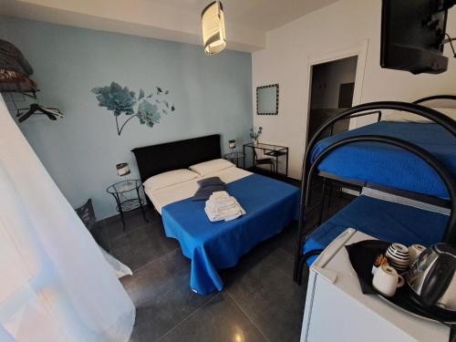 a bedroom with two bunk beds with blue sheets at B&B La Fenice in Pompei