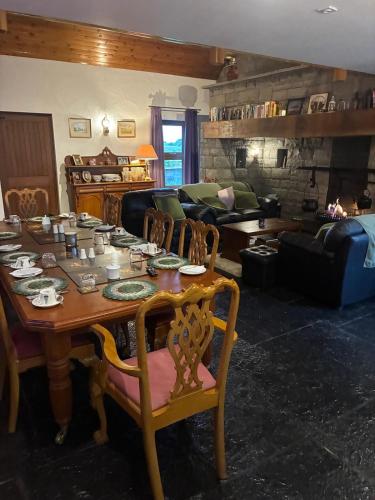 a living room with a table and a couch at Behan's Lodge in Doonbeg