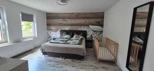 a bedroom with a bed and a mirror at Lindenplatz 6 in Sondershausen