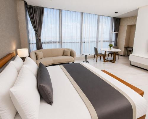 a bedroom with a large bed and a living room at Atlantic Suites Hotel in Georgetown
