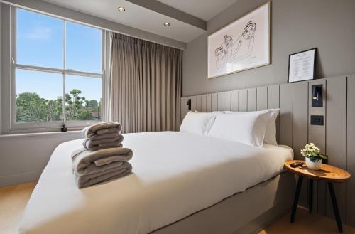 a bedroom with a white bed and a window at The Maida Hotel in London