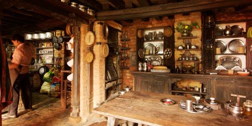 a kitchen with a wooden table in a room at The Famous Farm in Nawākot