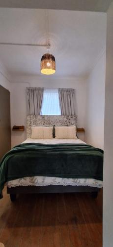 a bedroom with a large bed with a window at Hope's Harvest Nook in Montagu