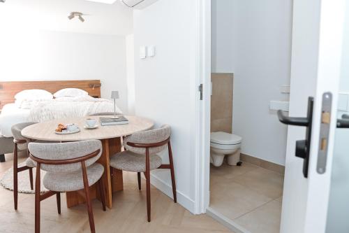 a room with a table and chairs and a bed at Residence Paradis in Zandvoort