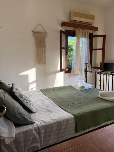 a large bed in a room with a window at Almyra Seaside Apartments in Elia Laconias