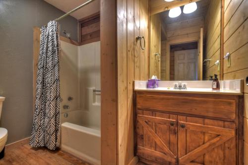 a bathroom with a sink and a tub and a toilet at Oscars Outpost Fire Pit Pet Friendly in Mineral Bluff