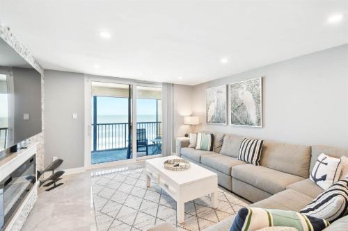 a living room with a couch and a table at Luxury Oceanfront Penthouse Condo in Clearwater Beach